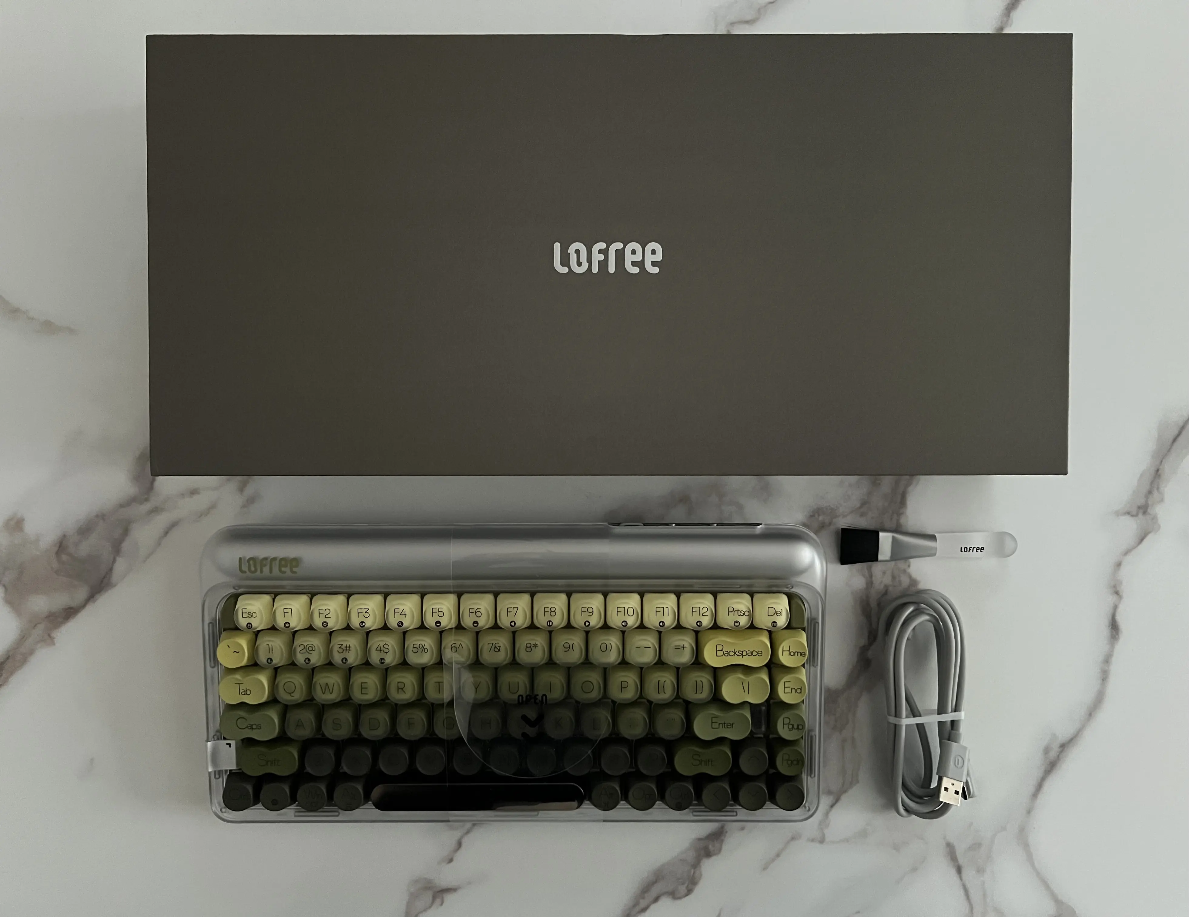 Lofree 432Hz Polar Moss et sa boîte avec câble USB, récepteur 2,4 GHz et brosse de nettoyage
